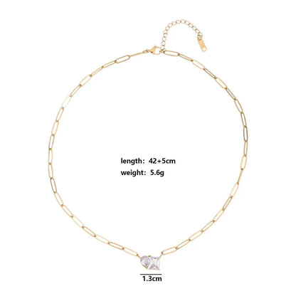Gold chain necklace with a diamond pendant on a white background