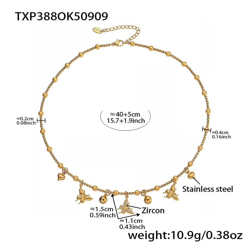 Gold necklace with charms and measurements on a white background