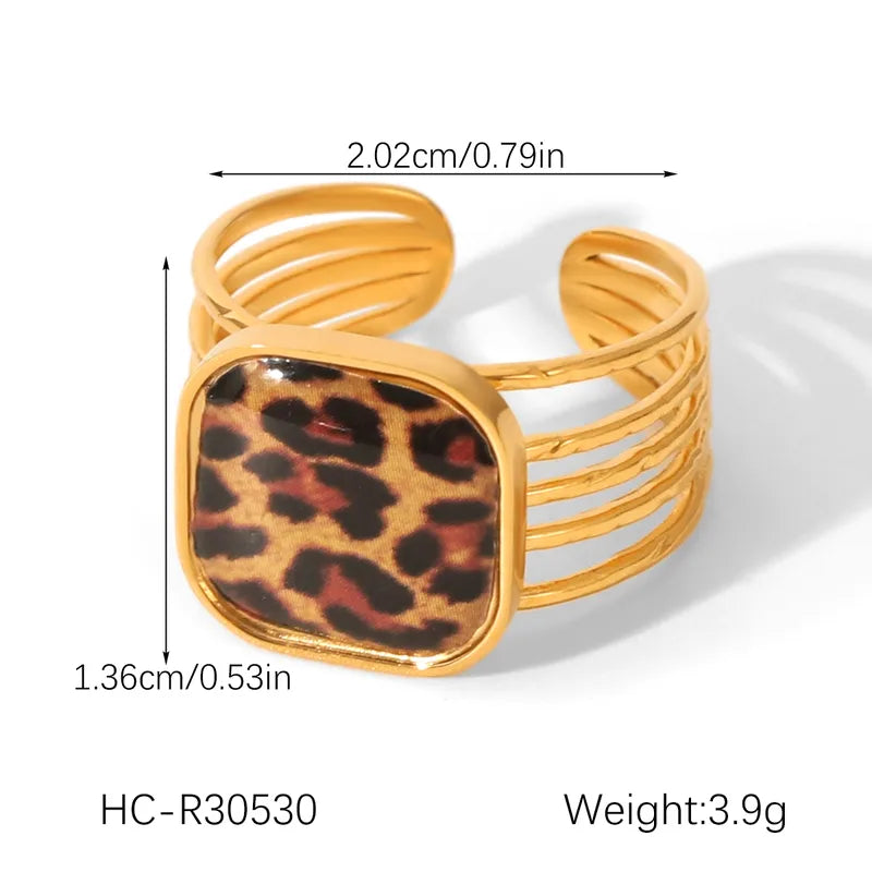 Gold bracelet with leopard print center and measurements on a white background