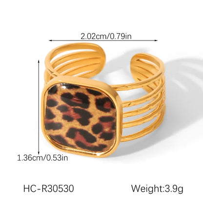 Gold bracelet with leopard print center and measurements on a white background