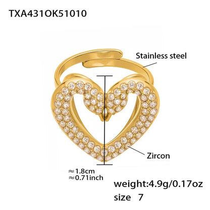 Gold heart-shaped ring with zircon stones and technical details on a white background