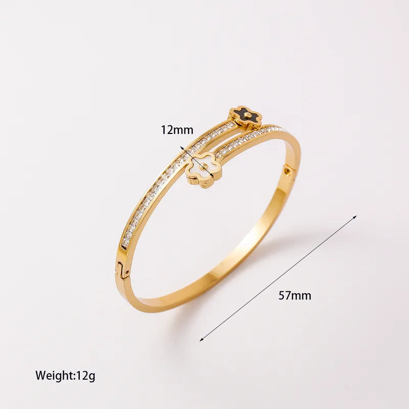 Gold bracelet with measurements on a white background
