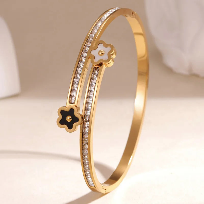 Gold bracelet with diamond accents on a beige background