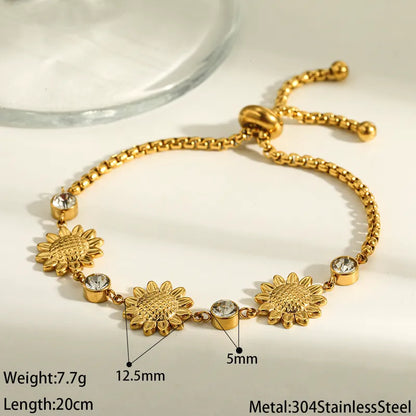Gold bracelet with sunflower designs and measurements on a light background