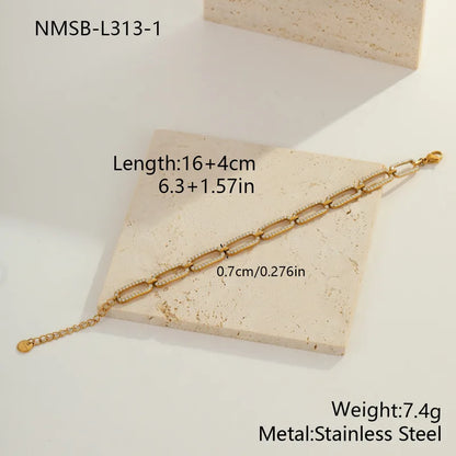 Gold chain bracelet on a beige stone surface with measurements and material details.