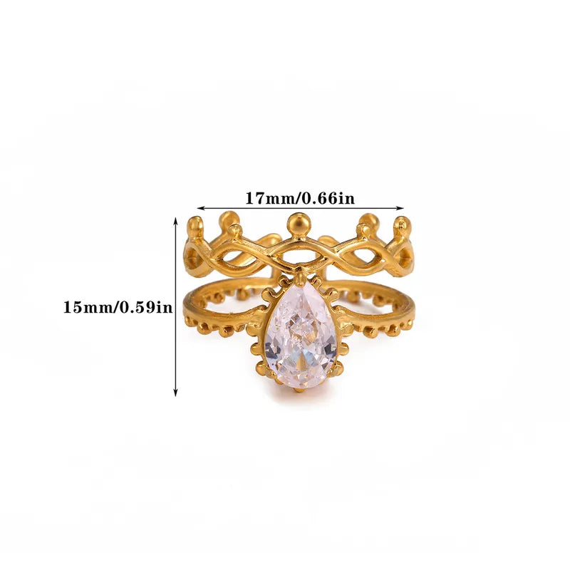 Gold ring with a teardrop-shaped gemstone and measurements on a white background