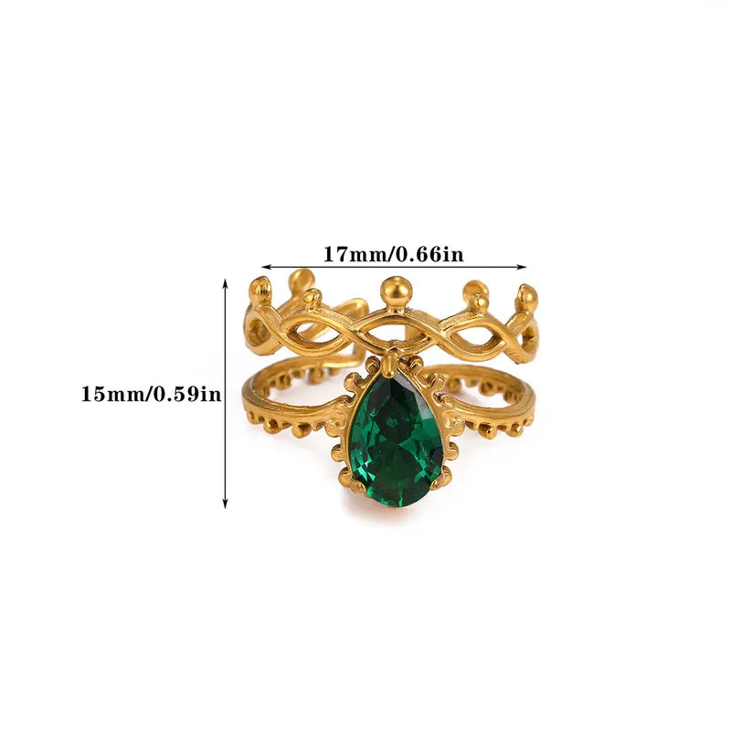 Gold ring with a green gemstone and measurements on a white background
