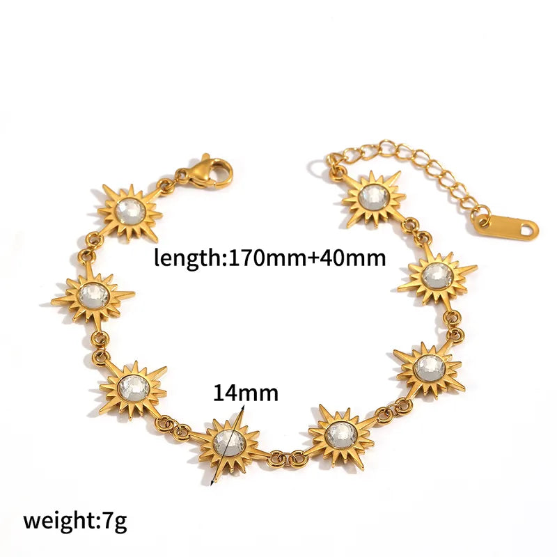 Gold bracelet with sun designs and measurements on a white background
