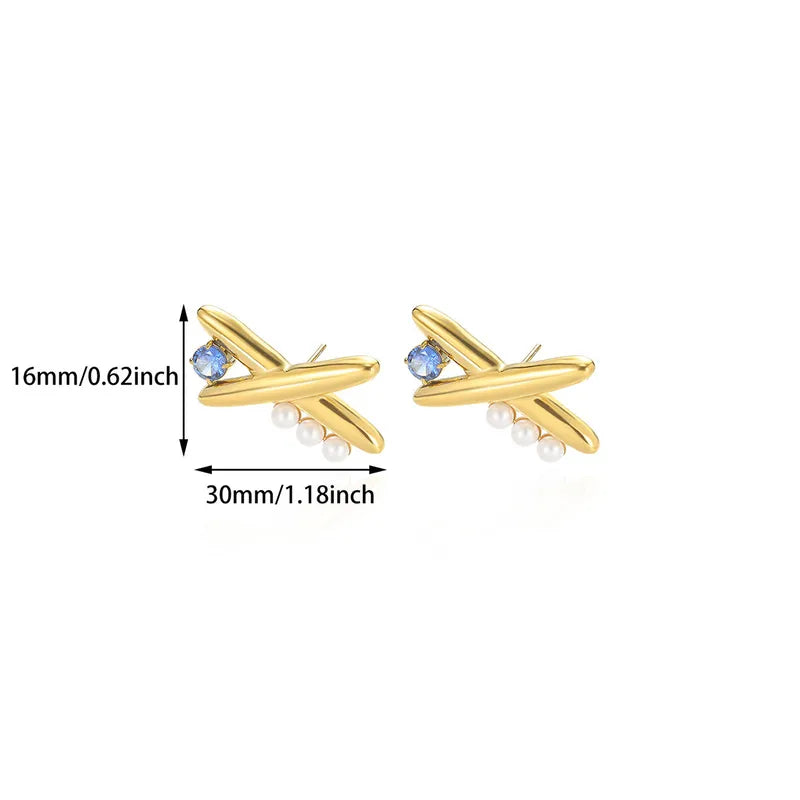 Gold airplane-shaped earrings with pearl accents and blue gemstones, shown with measurements on a white background.