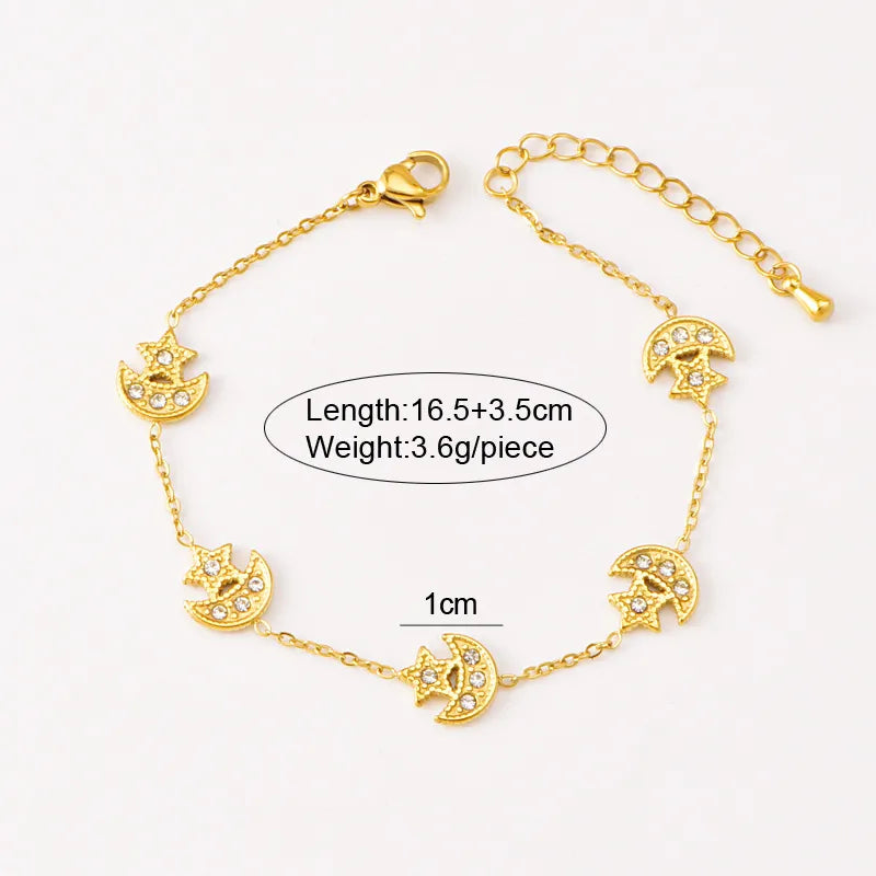 Gold bracelet with moon and star designs on a white background