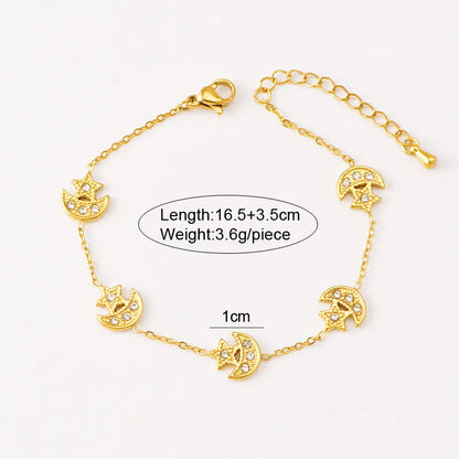 Gold bracelet with moon and star designs on a white background