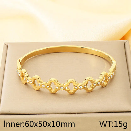 Gold bracelet on a beige box with dimensions and weight displayed.