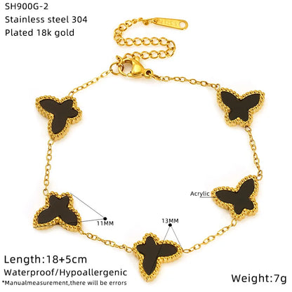 Gold bracelet with black butterfly charms on a white background