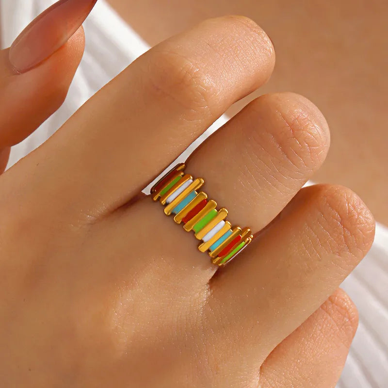 Colorful ring on a finger with a neutral background