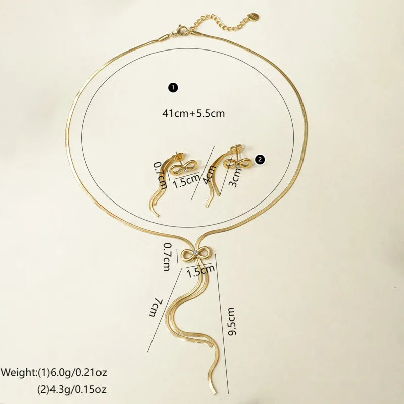 Gold necklace with measurements on a beige background