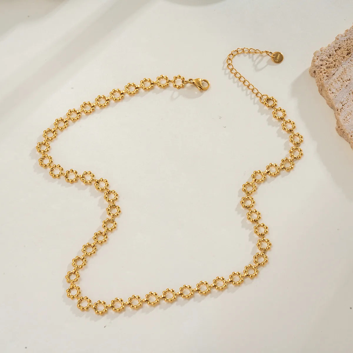 Gold chain necklace on a light background