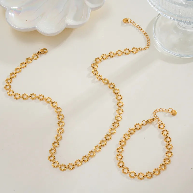 Gold chain necklace on a light surface