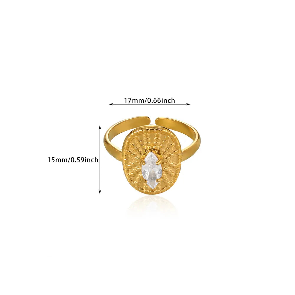 Gold ring with a clear gemstone, shown with measurements on a white background