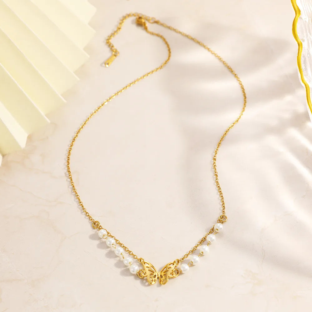 Gold necklace with pearls on a light fabric background