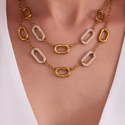 Gold and white chain necklace on a mannequin