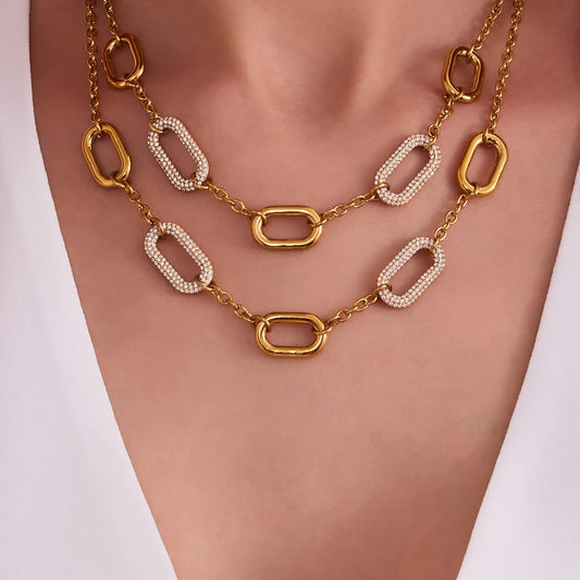 Gold and white chain necklace on a mannequin