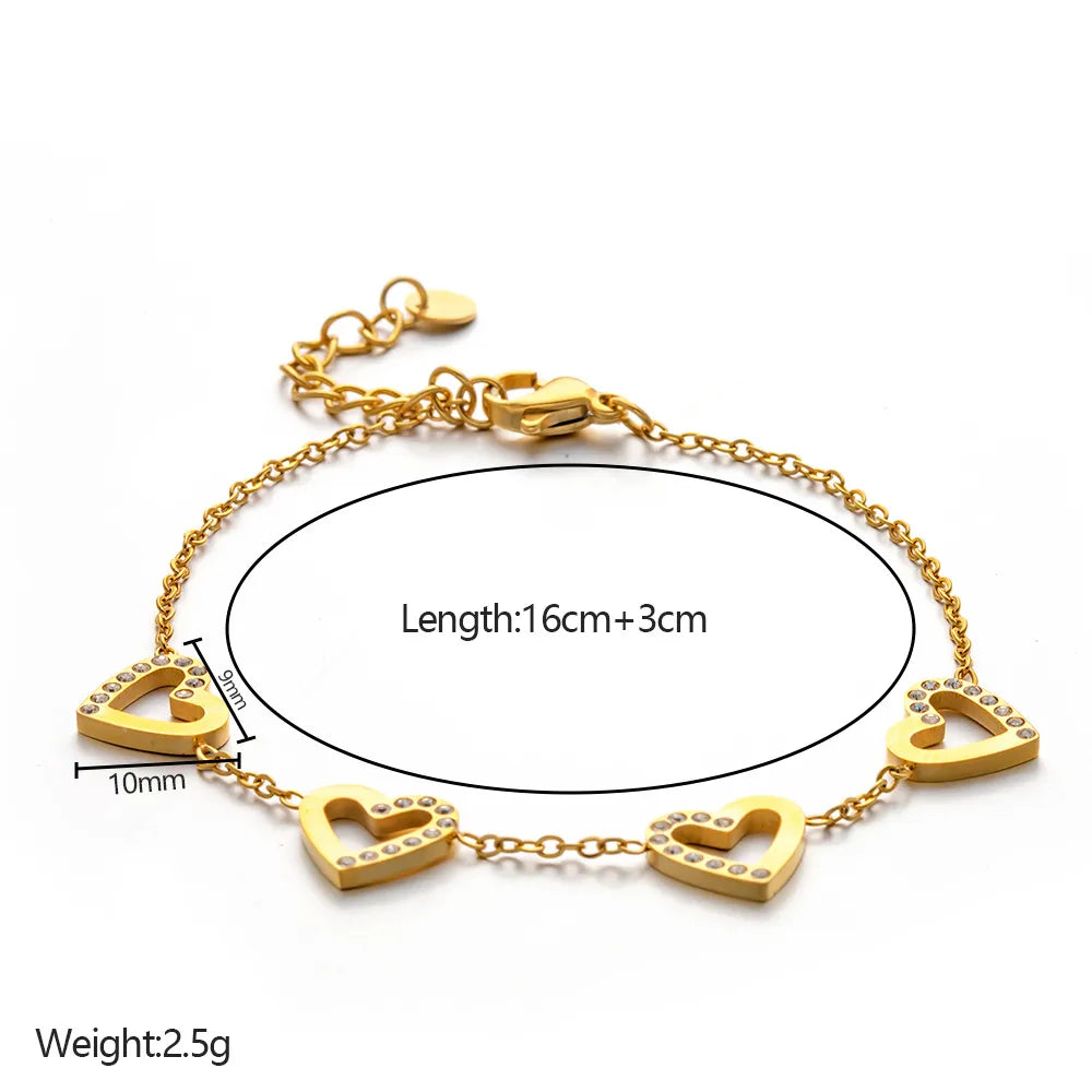 Gold bracelet with heart-shaped charms on a white background
