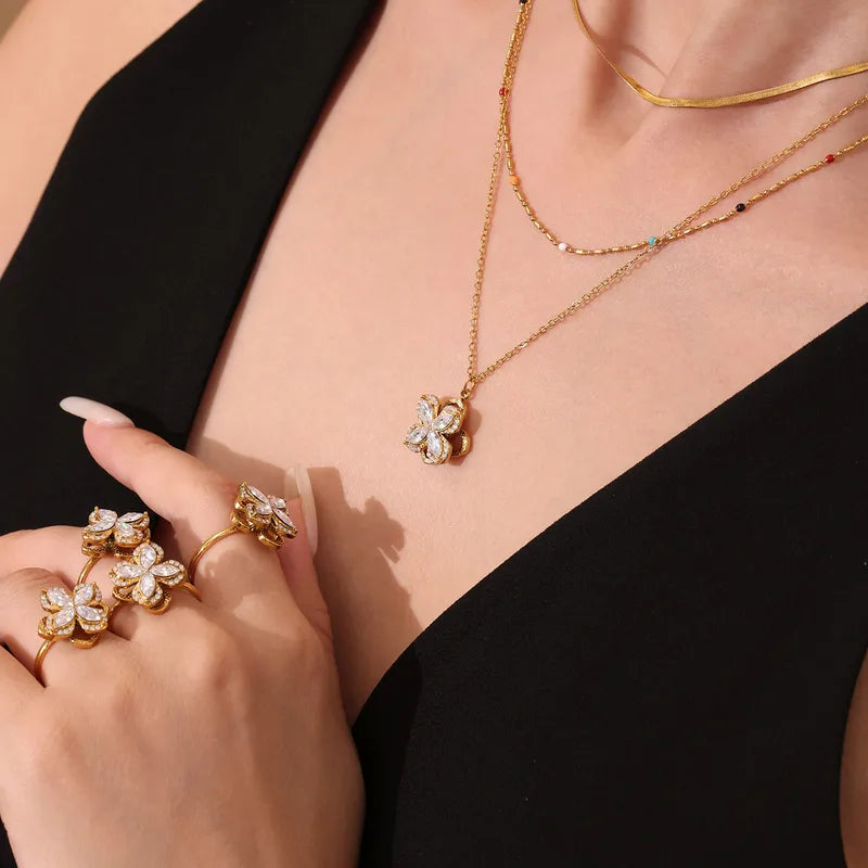 Gold jewelry set with floral designs on a black background