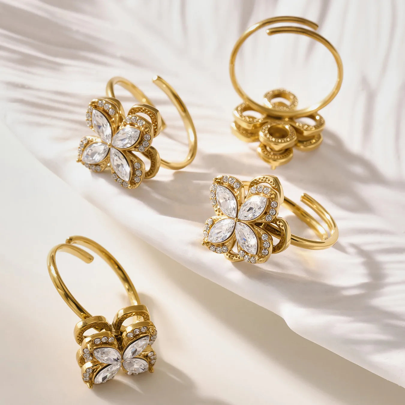 Gold butterfly-shaped earrings on a light fabric background
