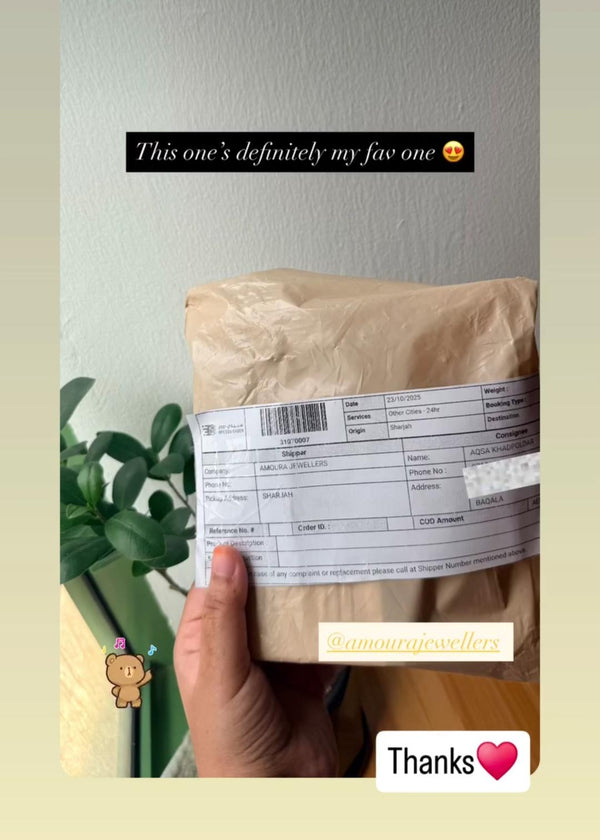 Hand holding a brown paper bag with a label, text overlay on a light gray background