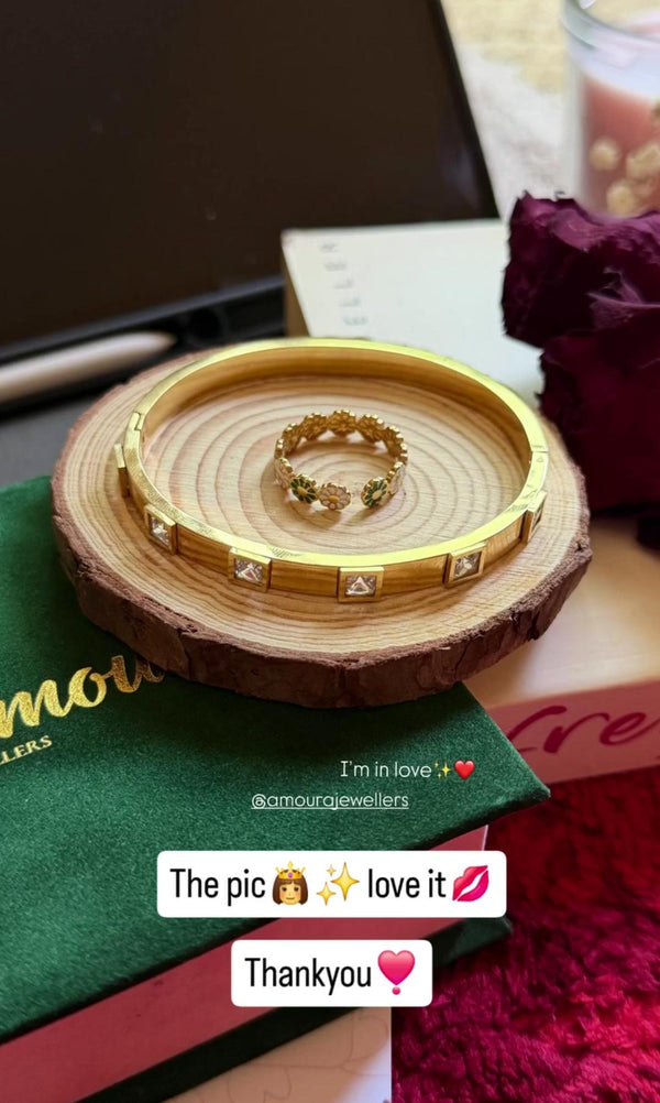 Gold ring and bangle on a wooden stand with text overlay expressing love and gratitude.
