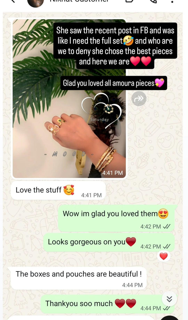 Text conversation on a social media platform with a hand wearing a gold bracelet.