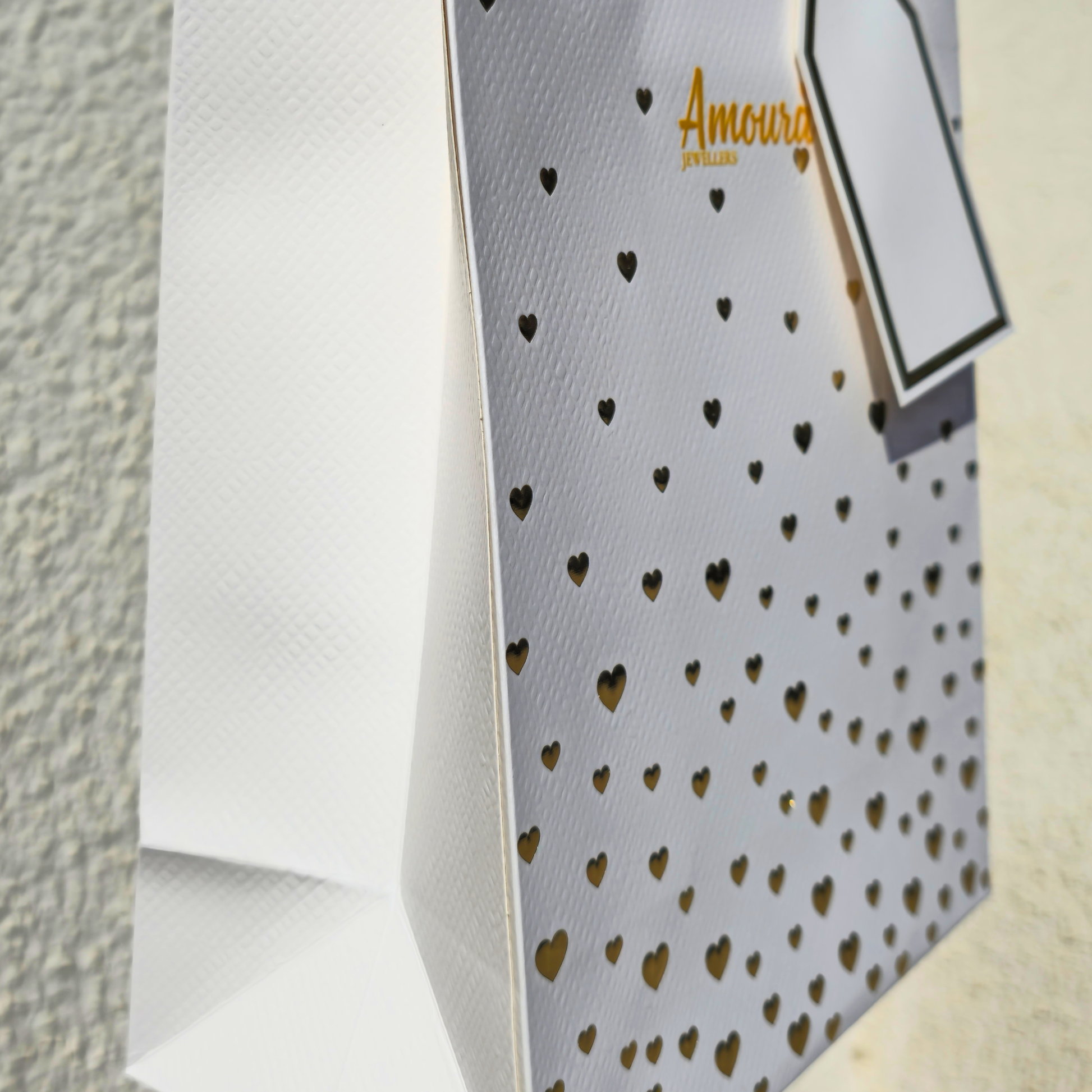 Gray tie with gold heart pattern on a textured surface