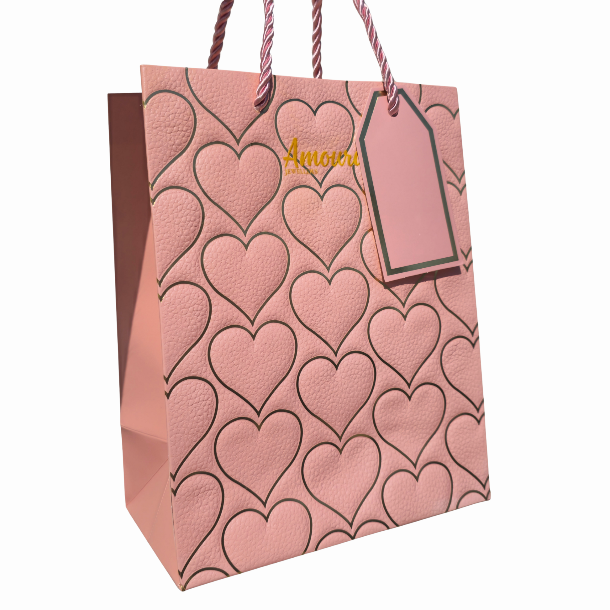 Pink gift bag with heart pattern and 'Amoura Jewellers' tag on a white background