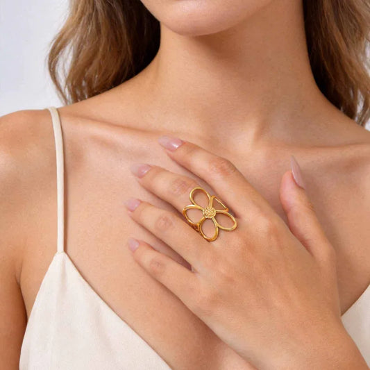 Woman wearing a gold flower-shaped ring on her hand