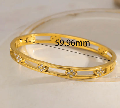 Gold bracelet with measurement label on a beige background